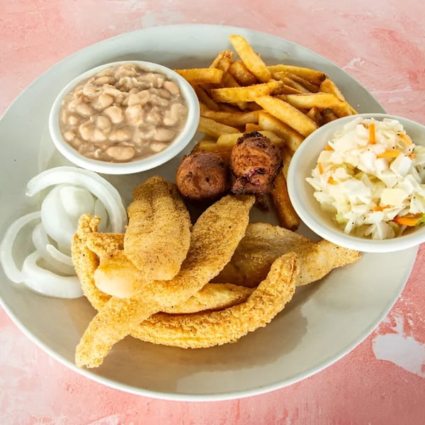 Redbone's fried catfish platter with fries, hush puppies, coleslaw, white beans, and sliced onions.