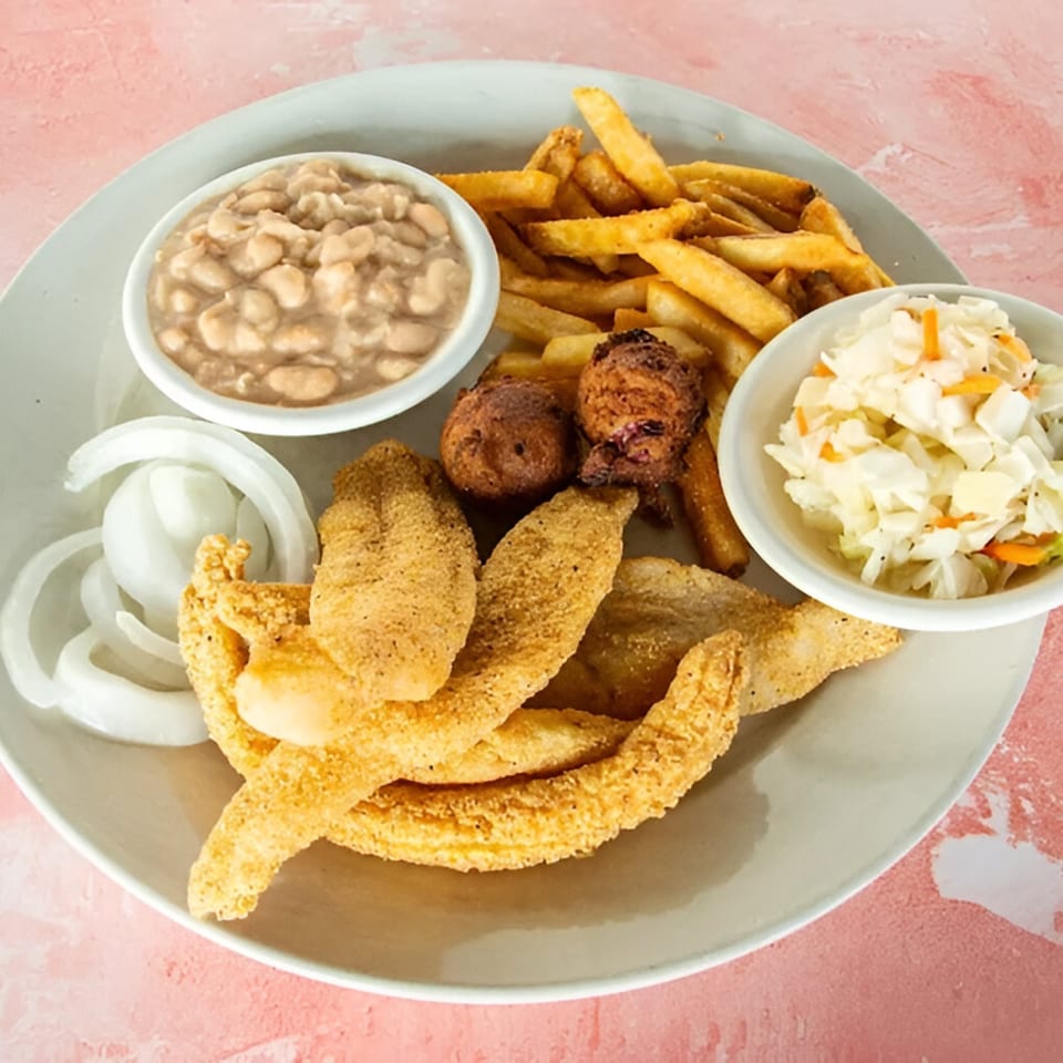 Redbone's fried catfish platter with fries, hush puppies, coleslaw, white beans, and sliced onions.